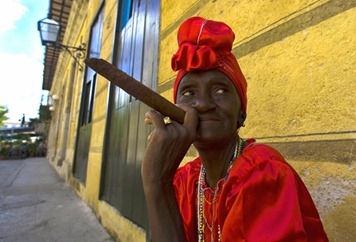 Cuban Virtudes smokes her Havana cigar in a street of Havana on February 23, 2008. Cuba's National Assembly was to select Sunday a successor to Fidel Castro, likely his brother Raul Castro, extending the Americas' only communist one-party regime in defiance of US-led calls for political opening.Fidel Castro lashed out at Western appeals for democracy in the days leading up to the vote, which will trigger some readjustments in the political chessboard even as the transition bears the exiting leader's imprint.Saturday, Fidel Castro wrote in another editorial that he was eagerly awaiting the "transcendental decision" of the National Assembly, and took a potshot at the US-based Organization of American States which does not allow Cuba to be a member due to its lack of democracy. AFP PHOTO LUIS ACOSTA (Photo credit should read LUIS ACOSTA/AFP/Getty Images)